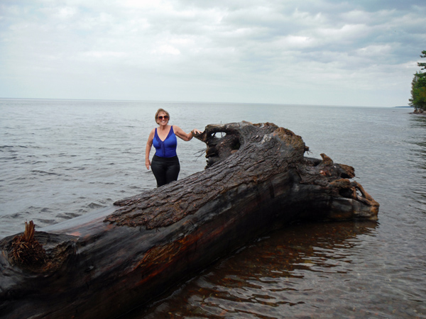 Karen Duquette and a tree stump in Lake Superior